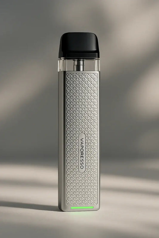 Vaporesso XROS 3 Mini Pod Vape Kit in silver, featuring a sleek rectangular body with a diamond-textured front panel and a green LED light at the base, placed against a unique gradient background.